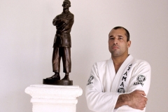 royce gracie in front of tribute staue to his father grandmaster helio gracie