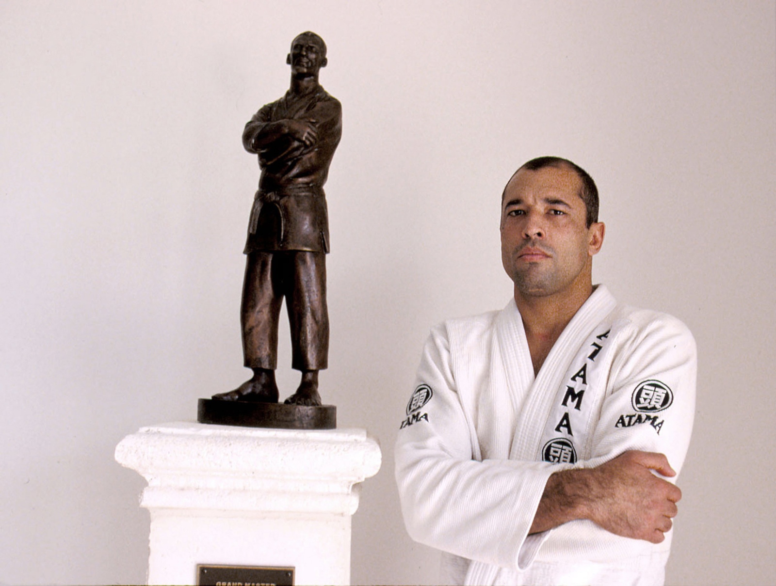 royce gracie in front of tribute staue to his father grandmaster helio gracie